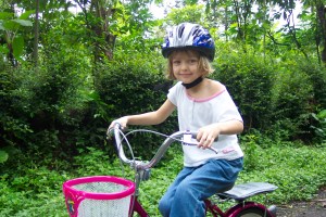 Anna on training wheels in Indonesia.